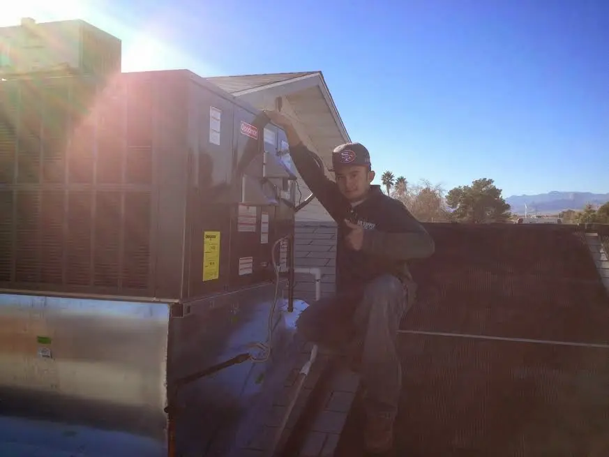 HVAC technician performing AC Tune-Up on a rooftop unit in Coto de Caza